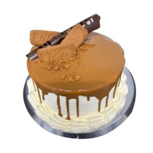 A cake topped with Lotus biscuits and a chocolate curl