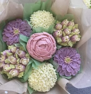 A beautiful Chitty's Cakes of Bromsgrove 7 cupcake bouquet in pastel shades
