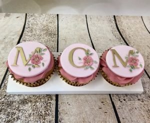 3 beautiful Chitty's Cakes cupcakes with plaques spelling MOM
